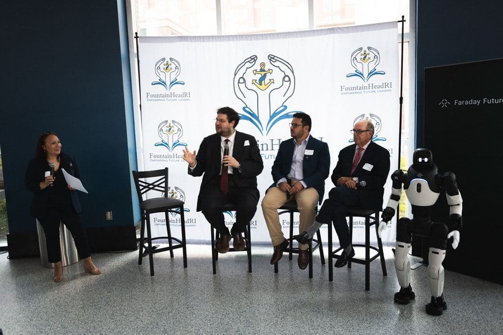 A panel discussion with FountainHead RI hosts and guests on stage.