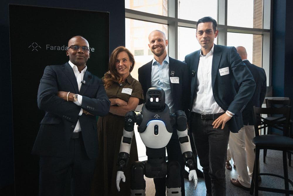Attendees standing with a demonstration robot at a FountainHead RI event.