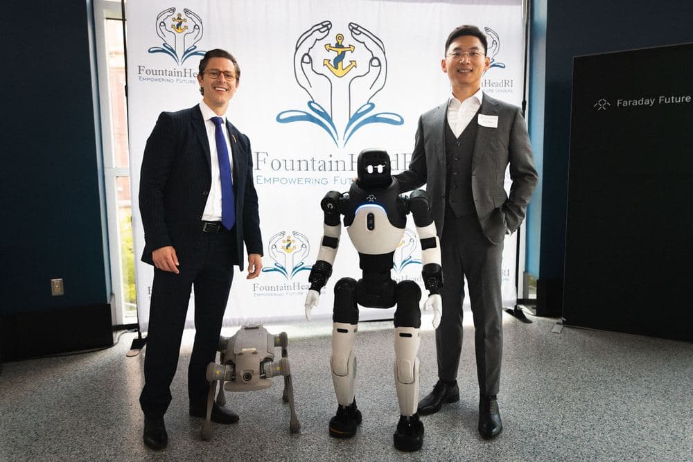Two attendees posing with a demonstration robot at a FountainHead RI event.