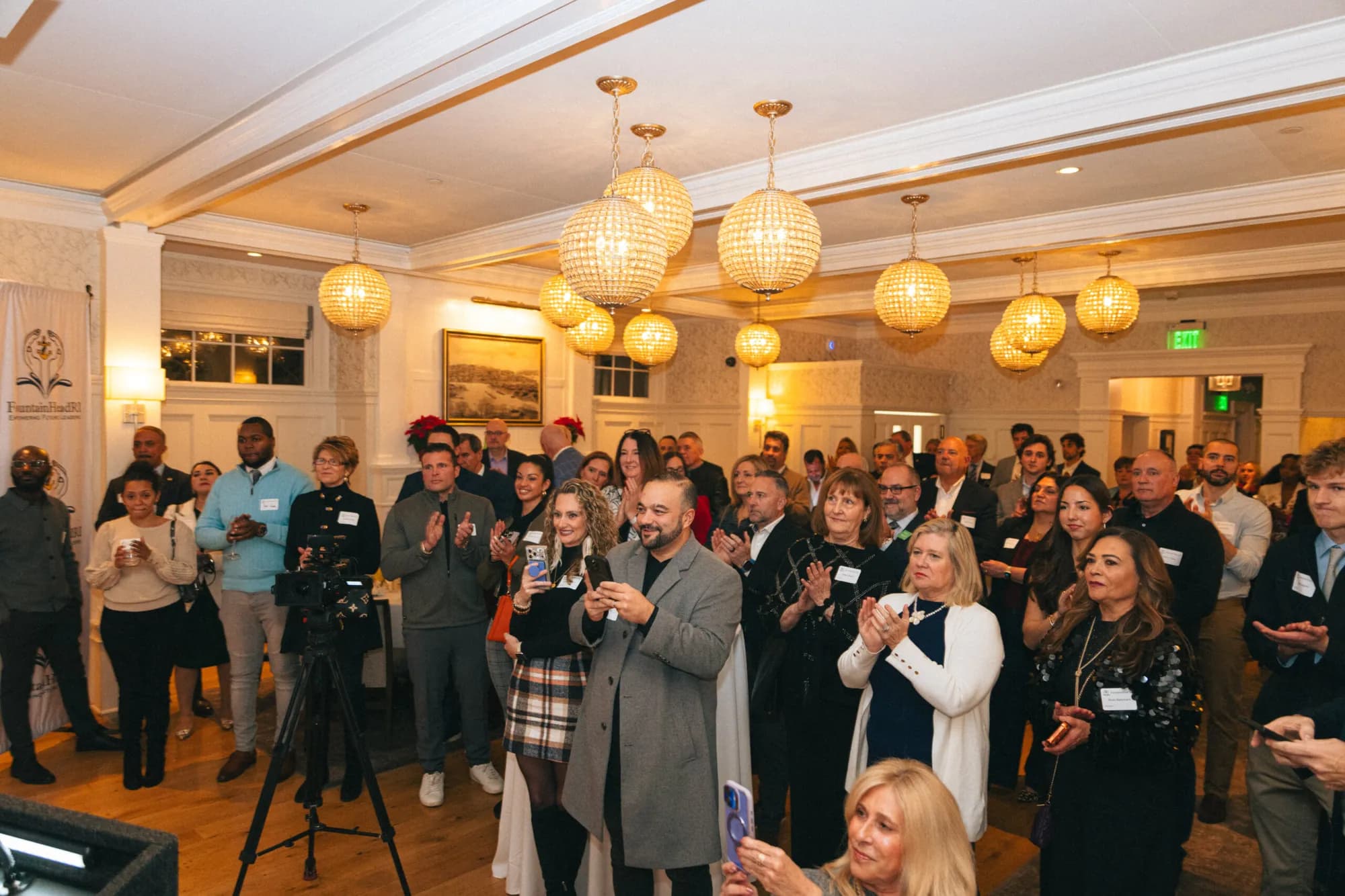 FountainHead RI members applauding at the December 2025 celebration