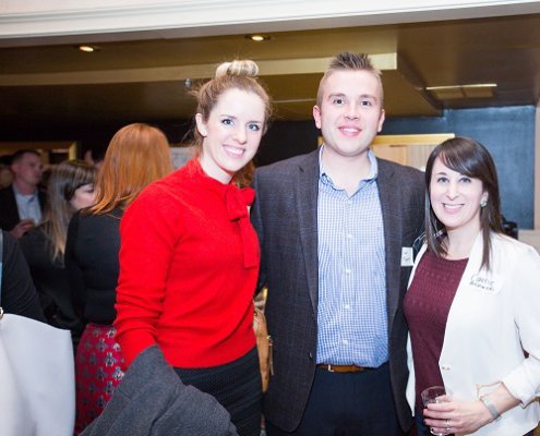 man and two women posing at networking event