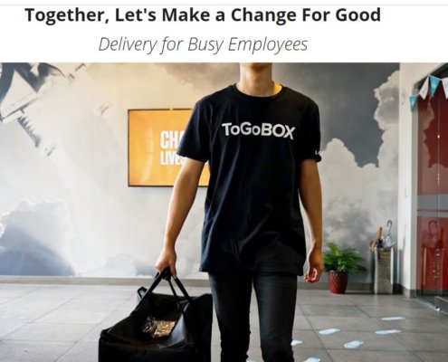 man wearing ToGoBox logo t-shirt carrying food warming bag