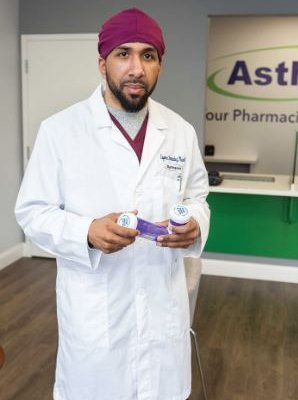 eugenio fernandez in medical coat holding prescription bottles