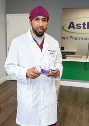 eugenio fernandez in medical coat holding prescription bottles