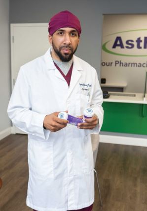 eugenio fernandez in medical coat holding prescription bottles