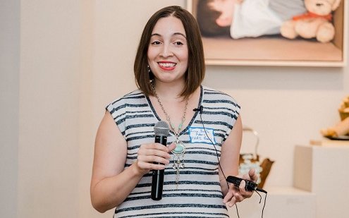 woman speaking holding microphone